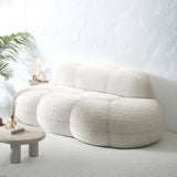 Cloud-shaped sofa styled in a bright, modern living room showing its cozy scale.